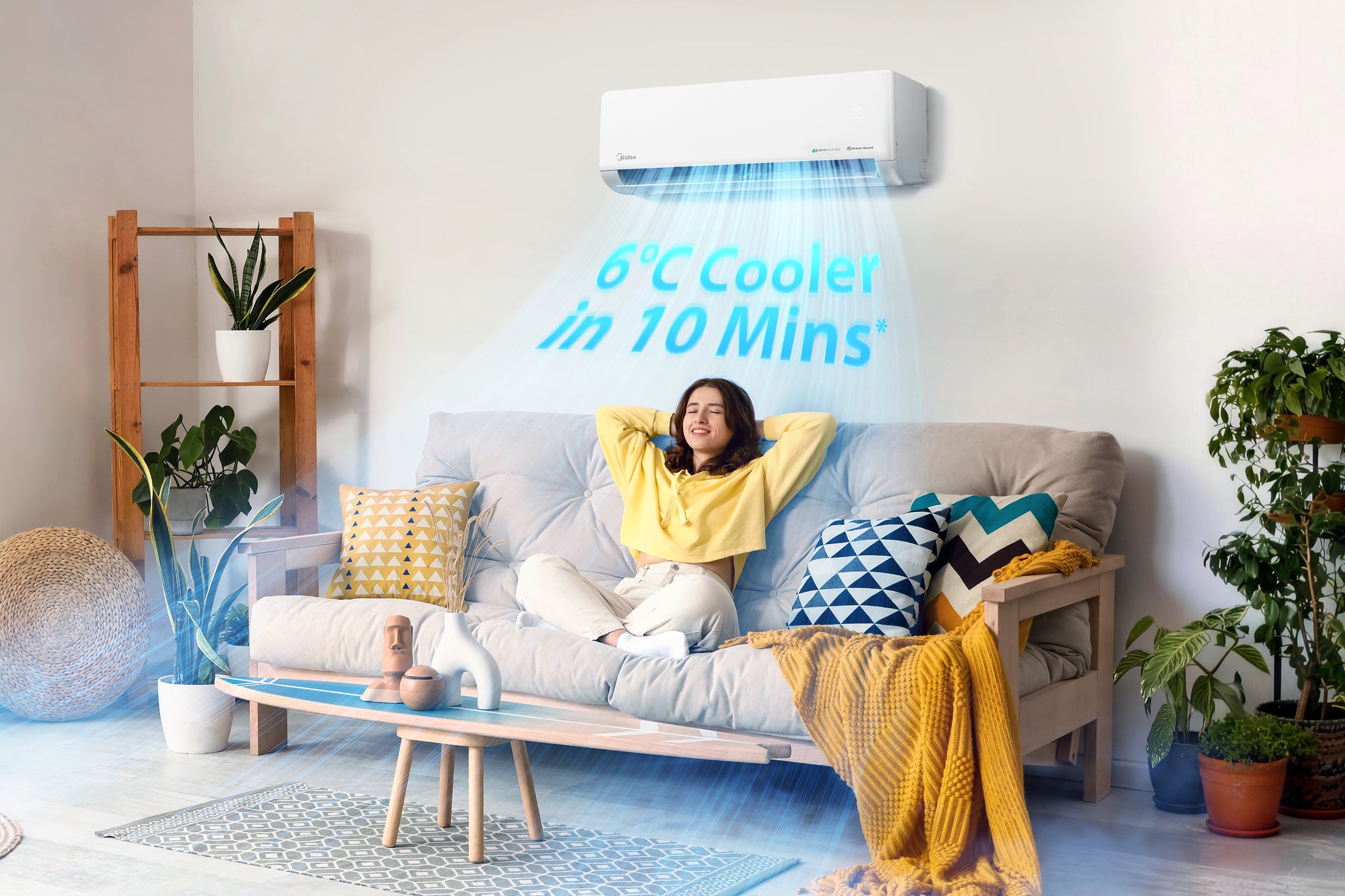 A Midea Edith Series split system on a living-room wall above a woman relaxing on a couch